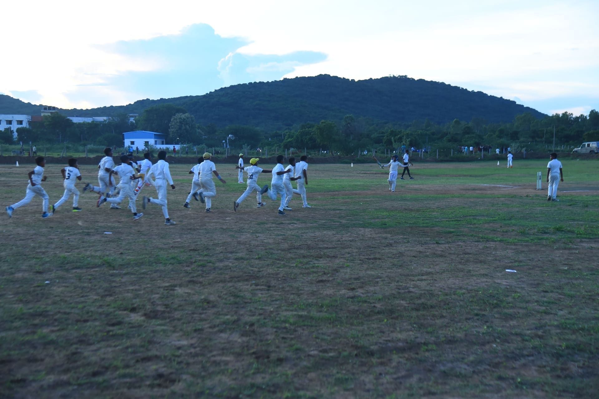 Junior cricketers celebrating a match win on the turf