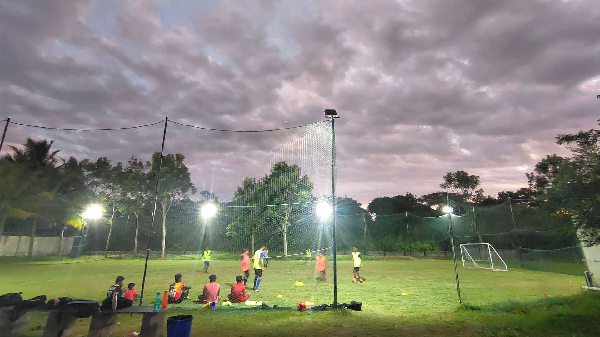 Floodlit turf football training session at night