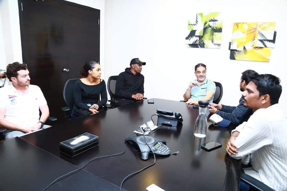 Sports agency executive leadership reviewing talent strategy with Kamal Haasan and Dwayne Bravo in an executive boardroom